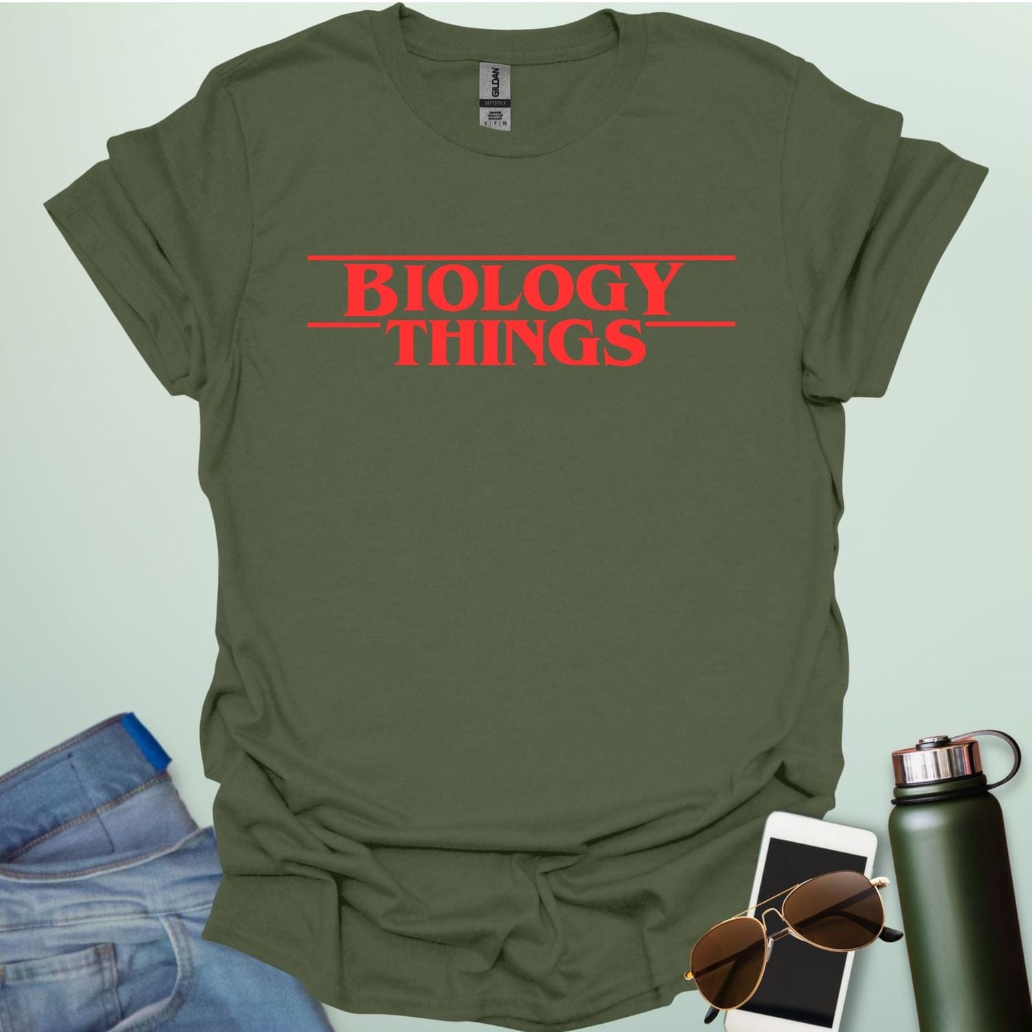 The words 'BIOLOGY' stacked above 'THINGS' in a red, stylized font with horizontal lines above and below, as a parody of the 'Stranger Things' logo.