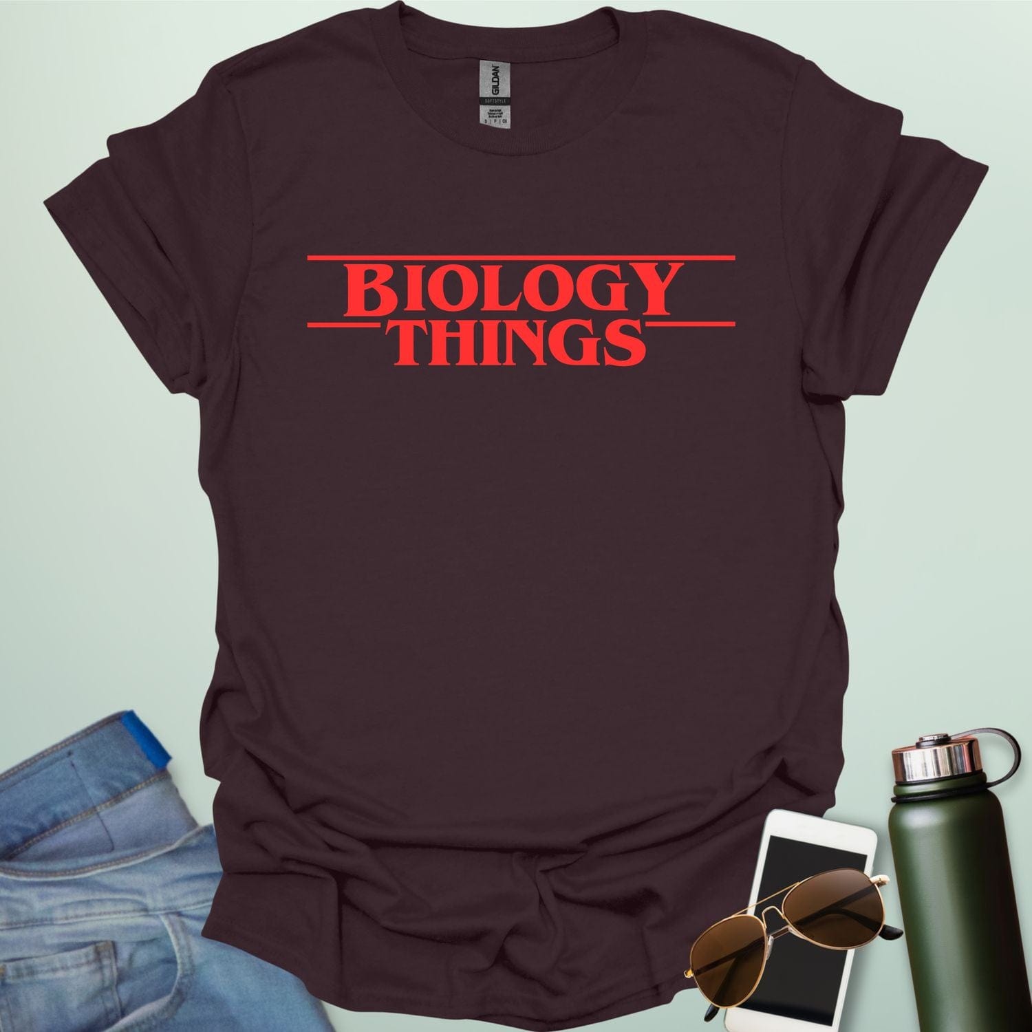 The words 'BIOLOGY' stacked above 'THINGS' in a red, stylized font with horizontal lines above and below, as a parody of the 'Stranger Things' logo.