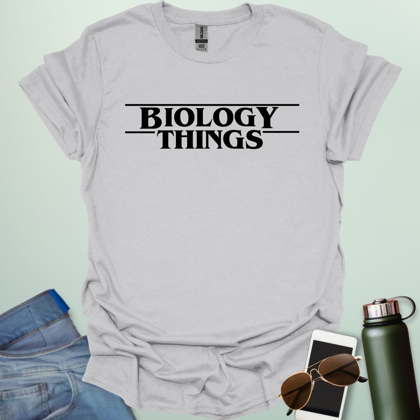 The words 'BIOLOGY' stacked above 'THINGS' in a red, stylized font with horizontal lines above and below, as a parody of the 'Stranger Things' logo.