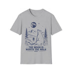 Vintage linocut-style illustration of a bear sitting beside a backpack, gazing up at a full moon over mountains and pine trees with text reading 'THE MOON IS WORTH THE WALK'.