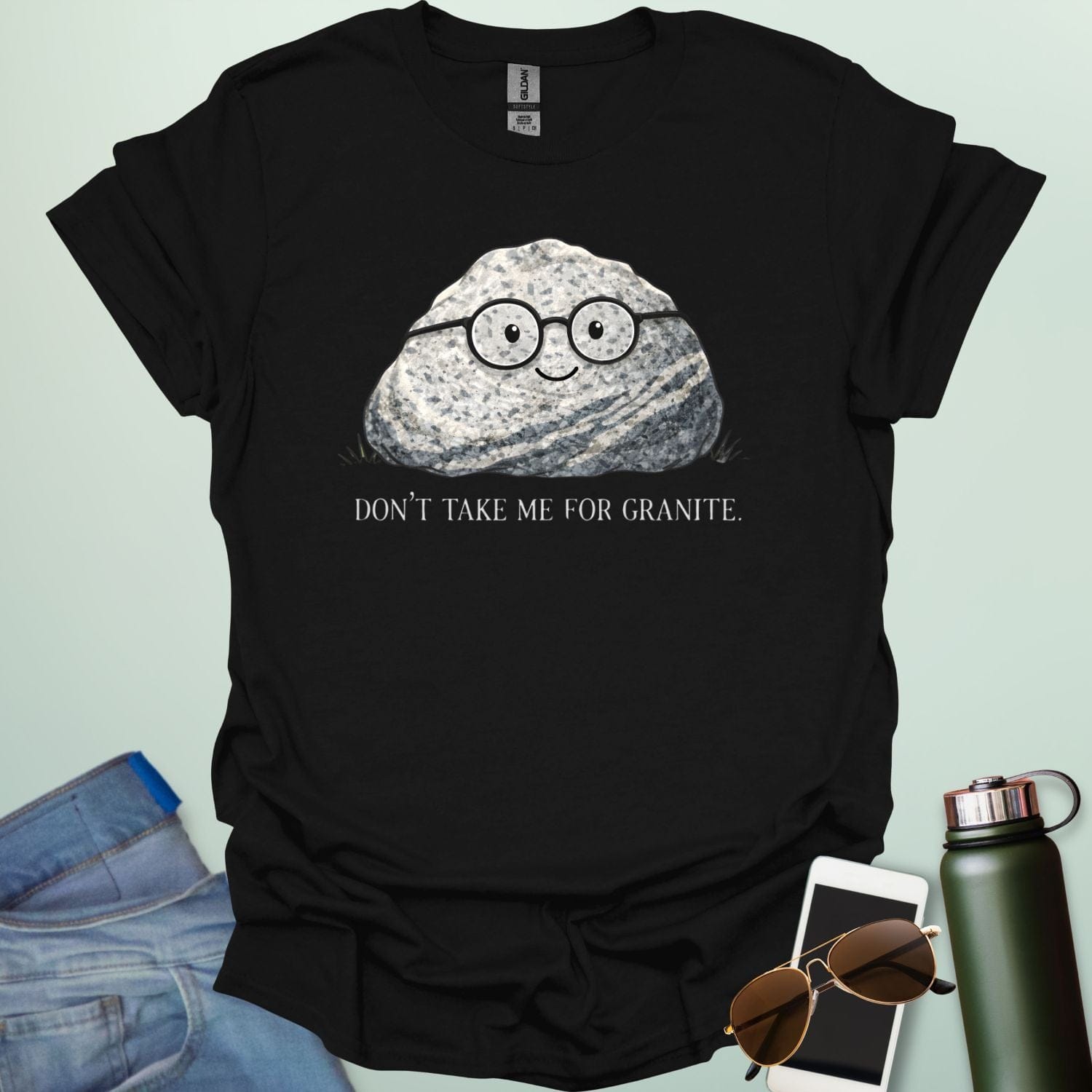 A playful science graphic featuring a cartoon rock character with a smiling face alongside the punny text "DON'T TAKE ME FOR GRANITE."