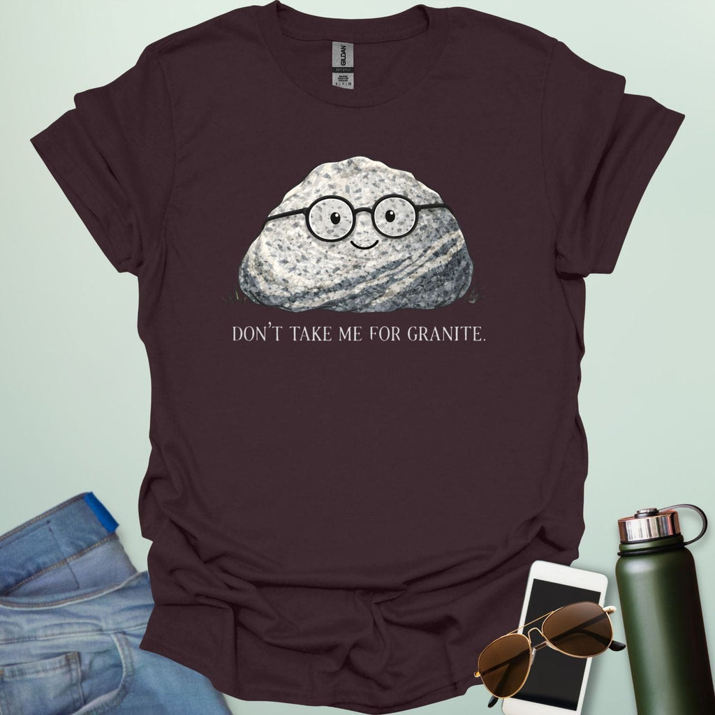 A playful science graphic featuring a cartoon rock character with a smiling face alongside the punny text "DON'T TAKE ME FOR GRANITE."