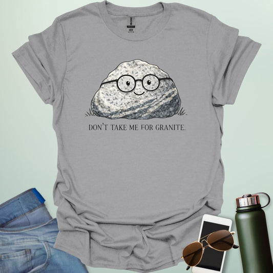 A playful science graphic featuring a cartoon rock character with a smiling face alongside the punny text "DON'T TAKE ME FOR GRANITE."