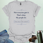 T-shirt with navy blue text reading 'Not everyone gets it. That's okay. My people do.' and 'STEM: SPEAK FLUENT CURIOSITY' with atom icons."