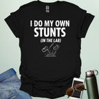 A bold graphic design featuring the text "I DO MY OWN STUNTS" in a large, blocky font with the subtext "(IN THE LAB)" positioned underneath.