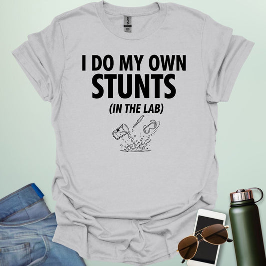 A bold graphic design featuring the text "I DO MY OWN STUNTS" in a large, blocky font with the subtext "(IN THE LAB)" positioned underneath.