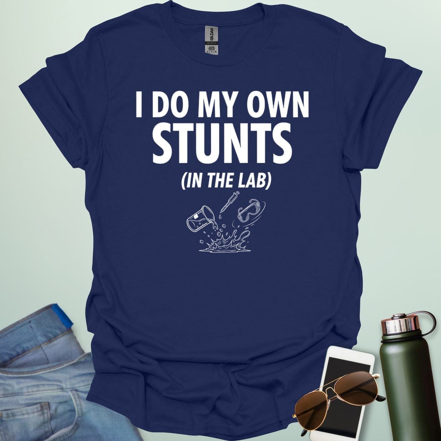 A bold graphic design featuring the text "I DO MY OWN STUNTS" in a large, blocky font with the subtext "(IN THE LAB)" positioned underneath.