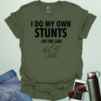 A bold graphic design featuring the text "I DO MY OWN STUNTS" in a large, blocky font with the subtext "(IN THE LAB)" positioned underneath.