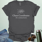 A stylish typography design featuring the words "CHAOS COORDINATOR (It's a technical term)" in a mix of bold and regular serif fonts, accented by minimalist scribbles on an XY graph.