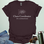 A stylish typography design featuring the words "CHAOS COORDINATOR (It's a technical term)" in a mix of bold and regular serif fonts, accented by minimalist scribbles on an XY graph.