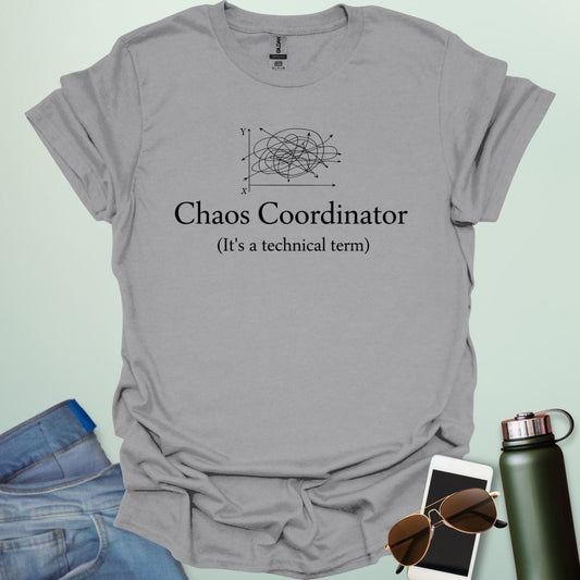 A stylish typography design featuring the words "CHAOS COORDINATOR (It's a technical term)" in a mix of bold and regular serif fonts, accented by minimalist scribbles on an XY graph.