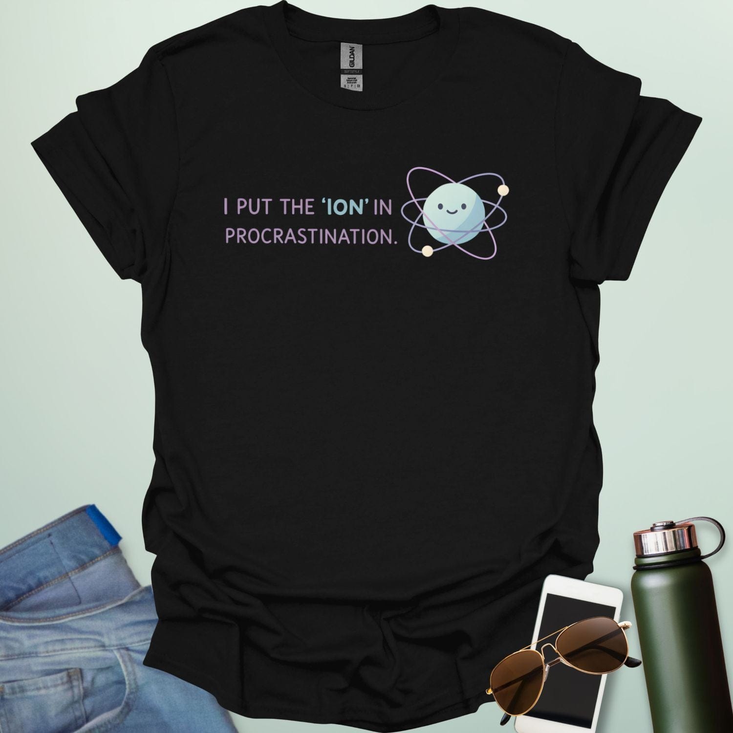 A playful science graphic featuring an atom or ion illustration with the punny text "I PUT THE 'ION' IN PROCRASTINATION" in a modern, rounded typeface.