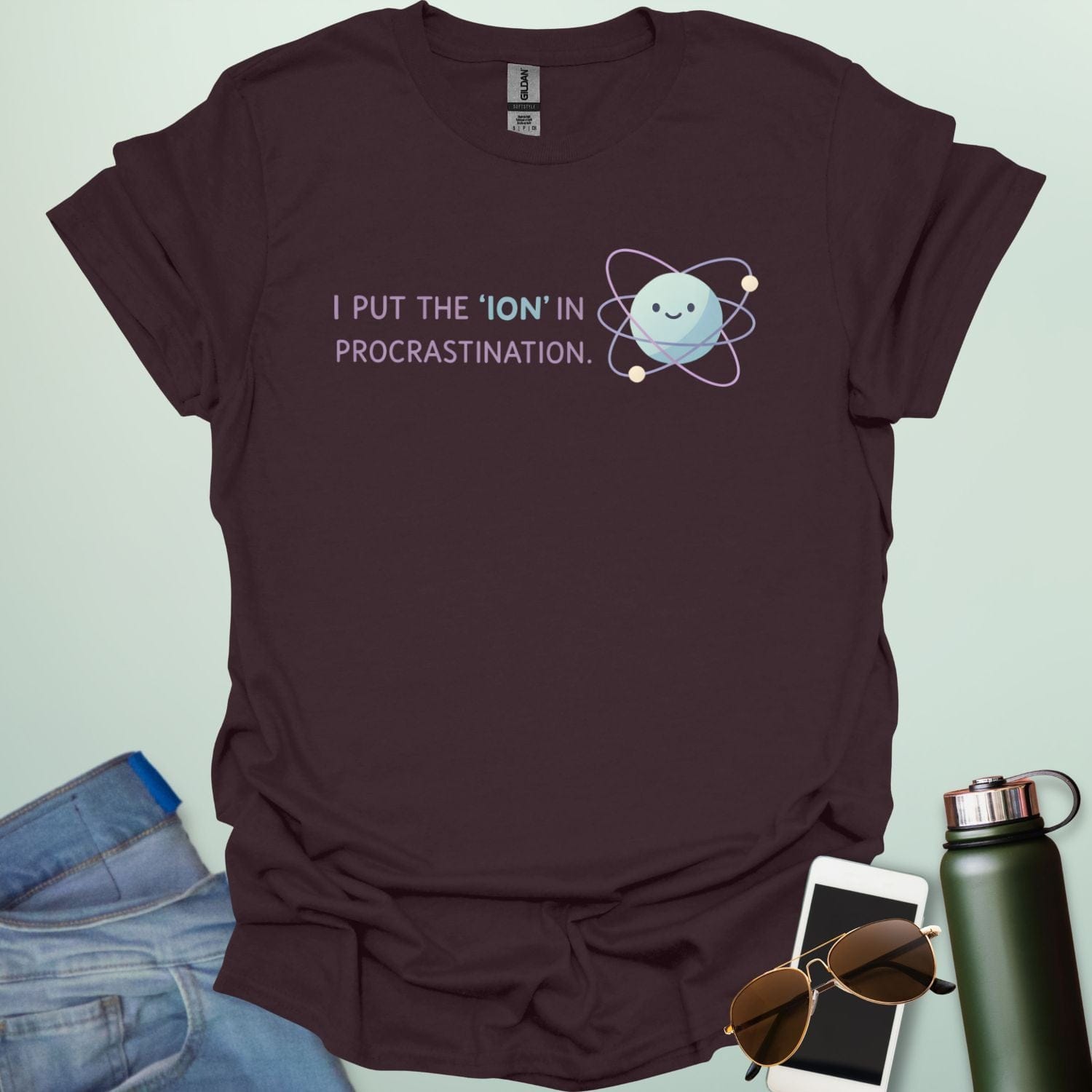 A playful science graphic featuring an atom or ion illustration with the punny text "I PUT THE 'ION' IN PROCRASTINATION" in a modern, rounded typeface.