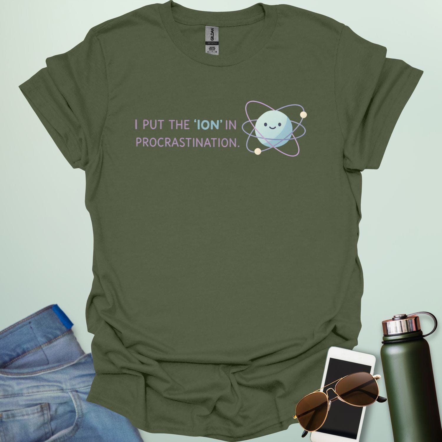 A playful science graphic featuring an atom or ion illustration with the punny text "I PUT THE 'ION' IN PROCRASTINATION" in a modern, rounded typeface.