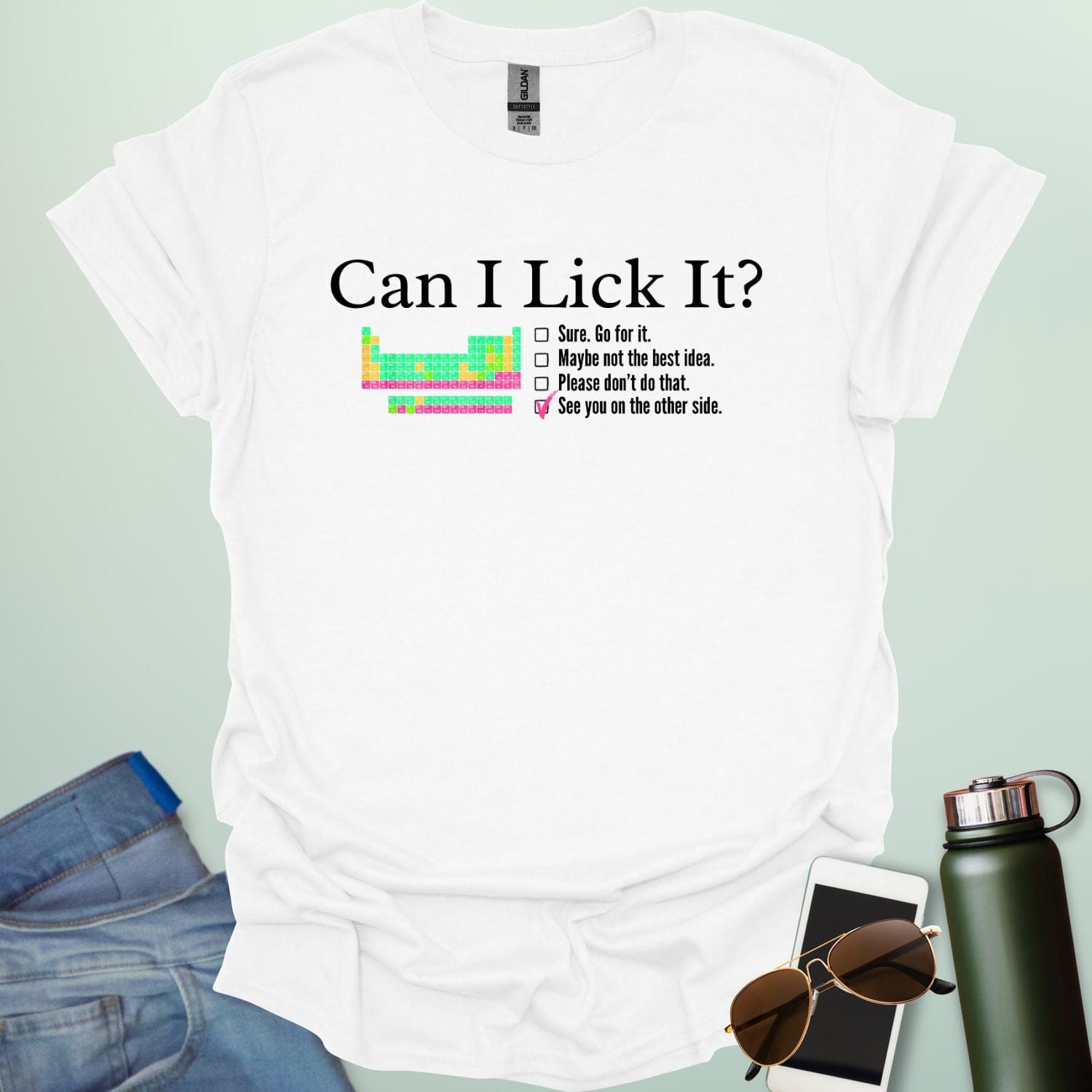 A playful science-themed graphic featuring the question "CAN I LICK IT?" in bold letters above a periodic table element-style box