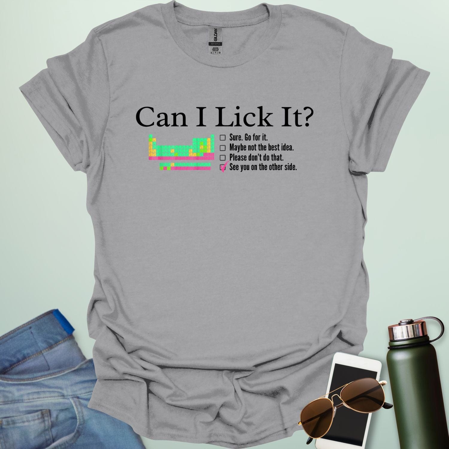 A playful science-themed graphic featuring the question "CAN I LICK IT?" in bold letters above a periodic table element-style box