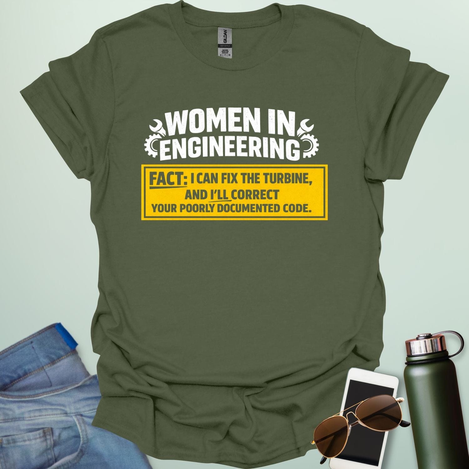 Graphic design featuring the text 'WOMEN IN ENGINEERING' with wrench and gear icons above a yellow box reading 'FACT: I CAN FIX THE TURBINE, AND I’LL CORRECT YOUR POORLY DOCUMENTED CODE.'