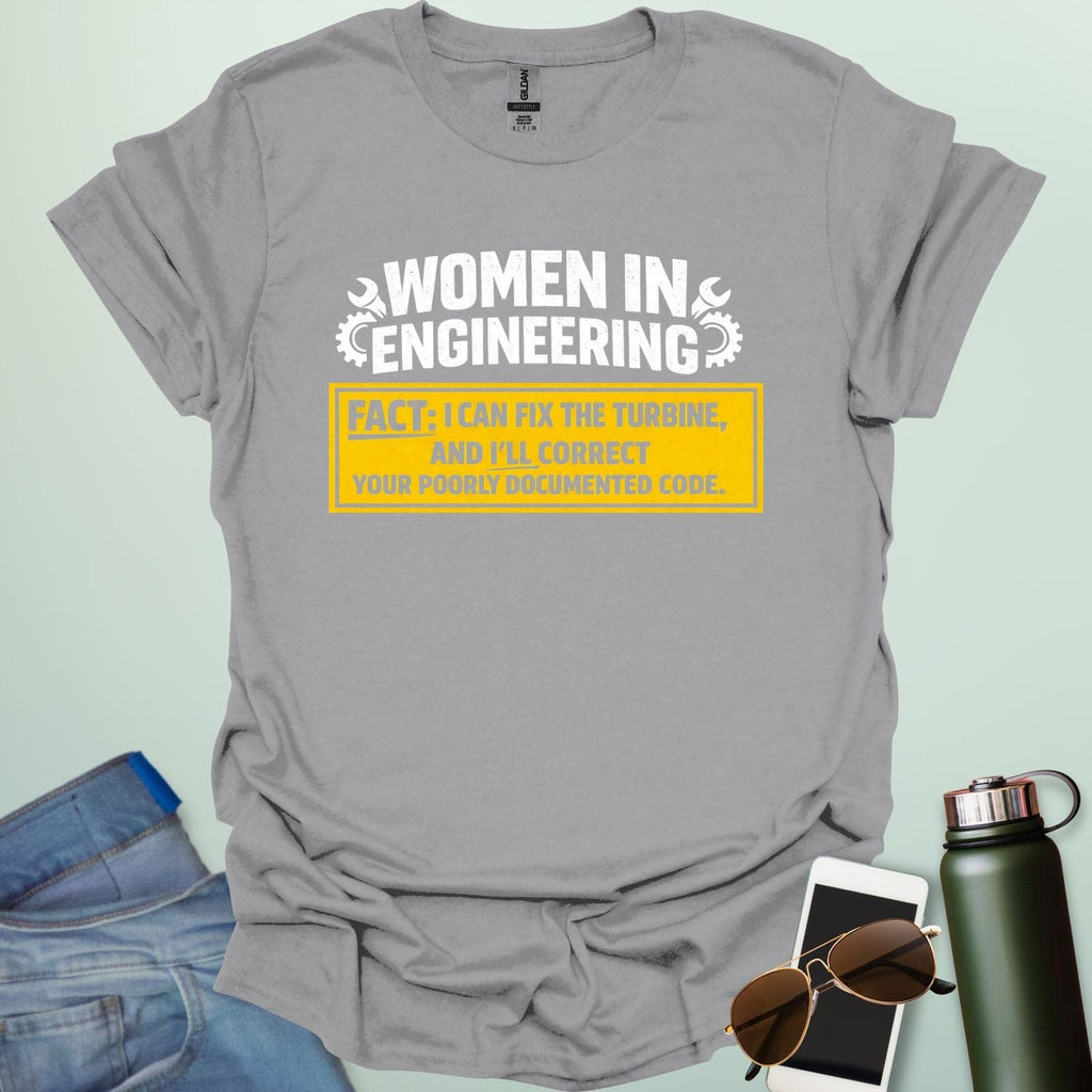 Graphic design featuring the text 'WOMEN IN ENGINEERING' with wrench and gear icons above a yellow box reading 'FACT: I CAN FIX THE TURBINE, AND I’LL CORRECT YOUR POORLY DOCUMENTED CODE.'