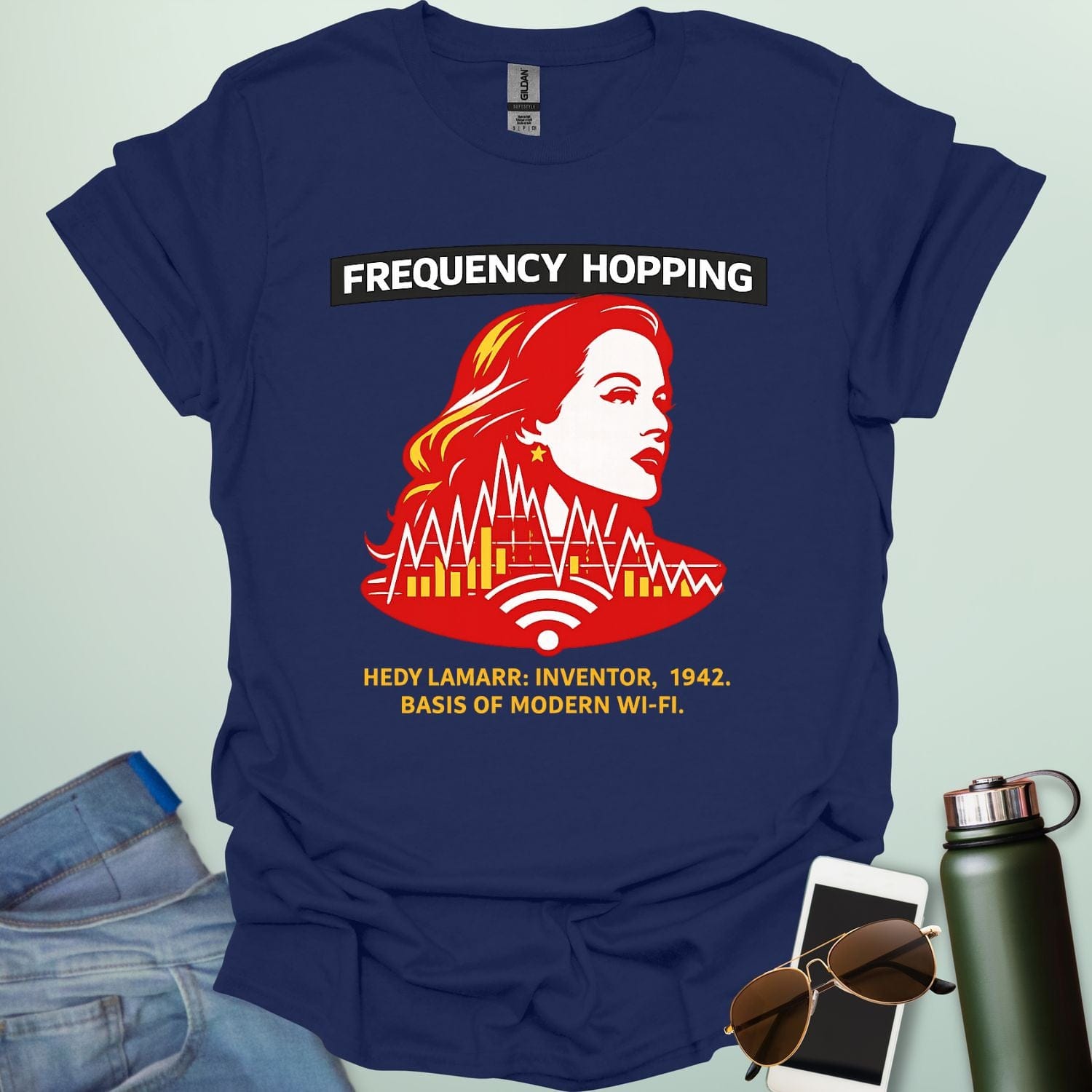 Graphic design featuring a stylized red and yellow portrait of Hedy Lamarr with signal wave patterns, Wi-Fi icons, and text reading 'FREQUENCY HOPPING' and 'HEDY LAMARR: INVENTOR, 1942. BASIS OF MODERN WI-FI.'