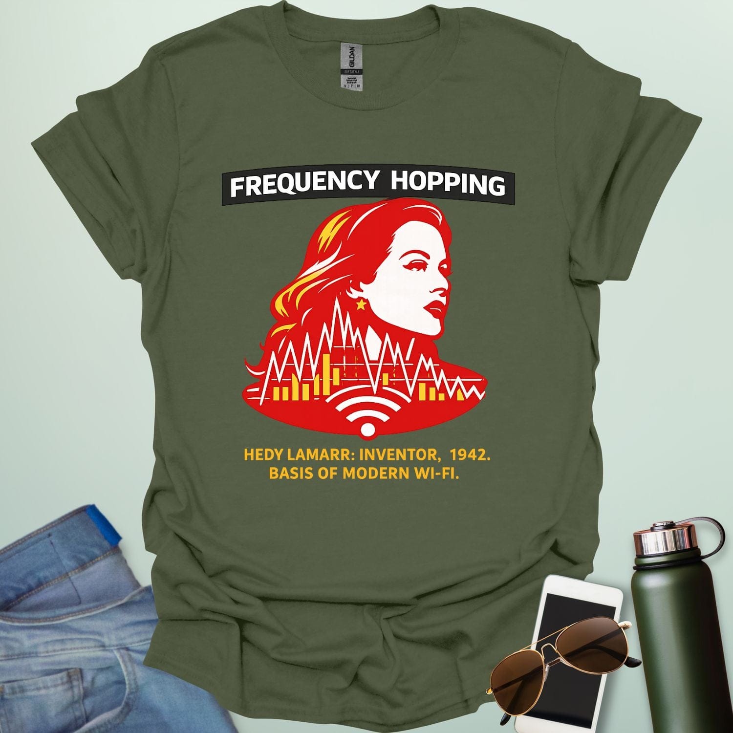 Graphic design featuring a stylized red and yellow portrait of Hedy Lamarr with signal wave patterns, Wi-Fi icons, and text reading 'FREQUENCY HOPPING' and 'HEDY LAMARR: INVENTOR, 1942. BASIS OF MODERN WI-FI.'