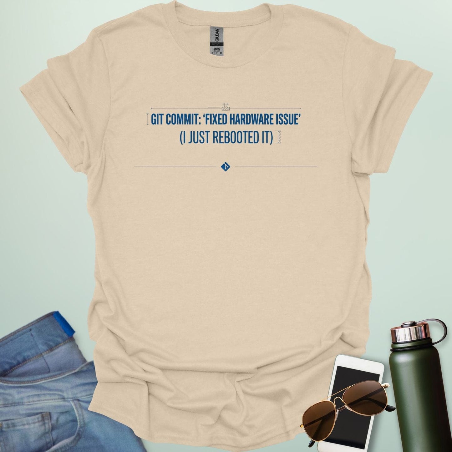 Graphic design featuring the text 'GIT COMMIT: FIXED HARDWARE ISSUE (I JUST REBOOTED IT)' with a Git logo icon and stylized coding bracket accents.