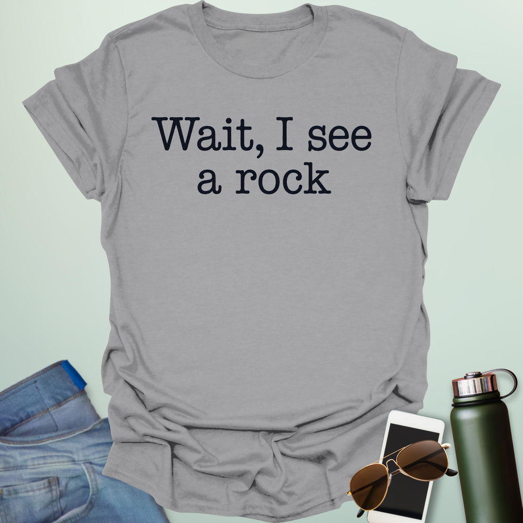 Graphic typography design featuring typewriter-style text reading 'Wait, I see a rock'.