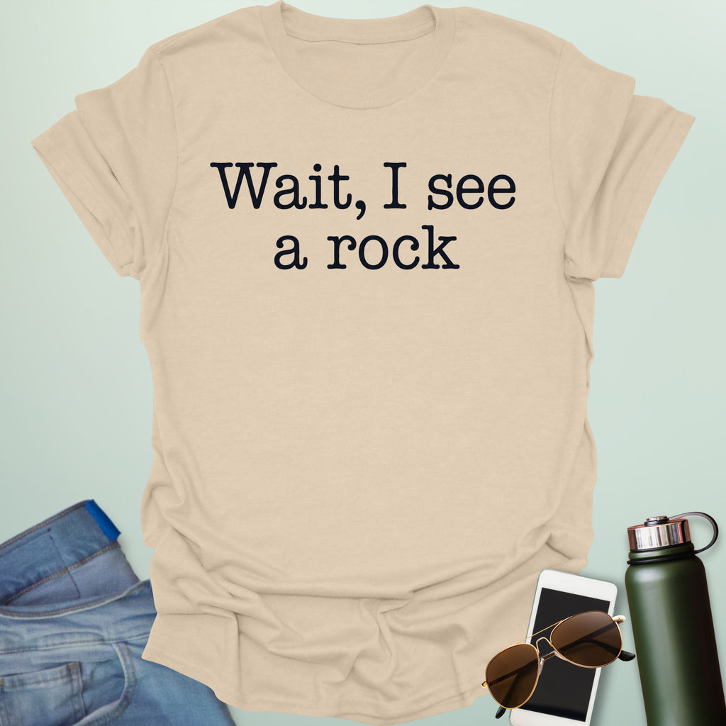 Graphic typography design featuring typewriter-style text reading 'Wait, I see a rock'.