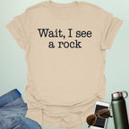 Graphic typography design featuring typewriter-style text reading 'Wait, I see a rock'.