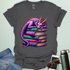 Dragon Fantasy t-shirt featuring whimsical purple dragon curled on a stack of books — perfect for fantasy fans, book lovers, and story geeks.