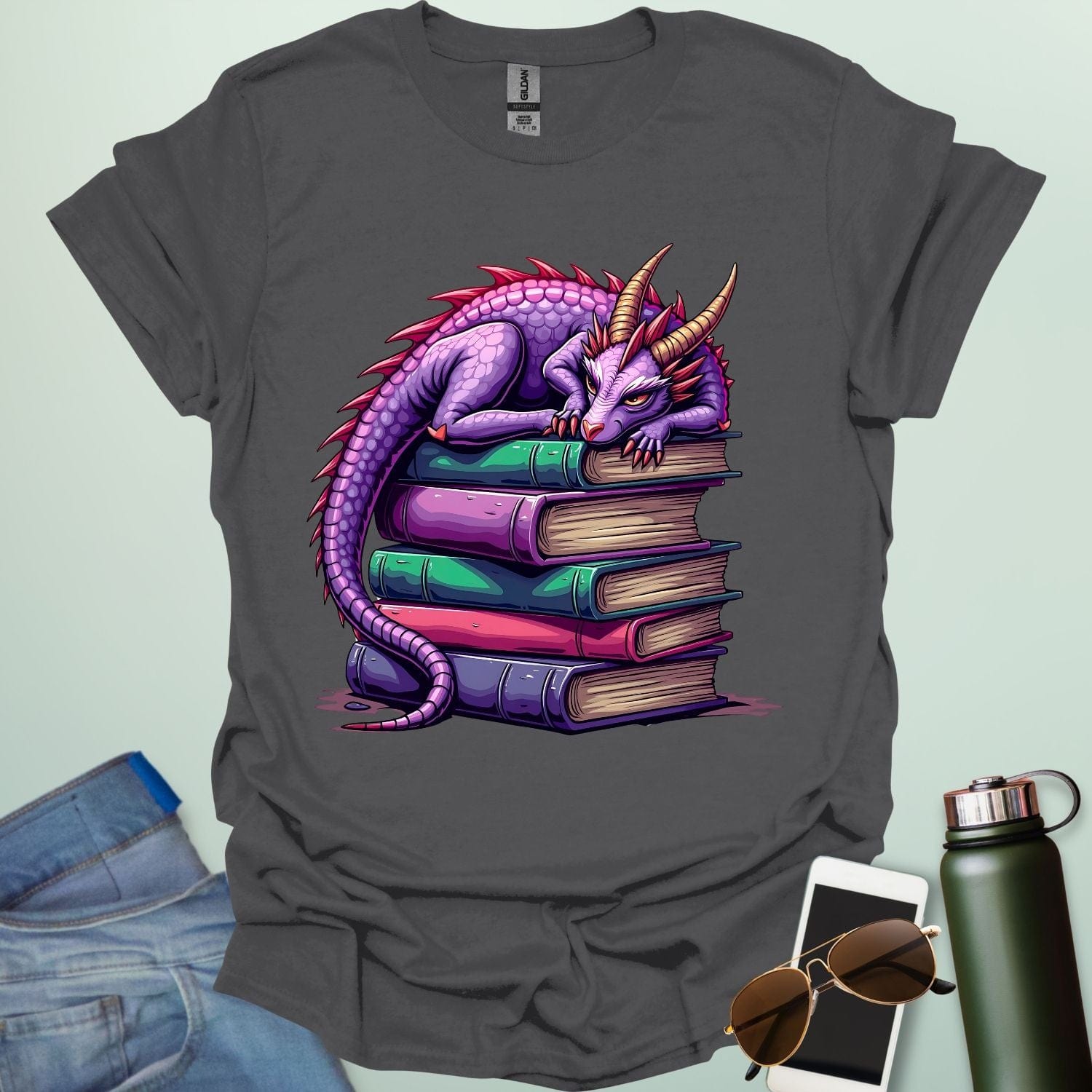 Dragon Fantasy t-shirt featuring whimsical purple dragon curled on a stack of books — perfect for fantasy fans, book lovers, and story geeks.