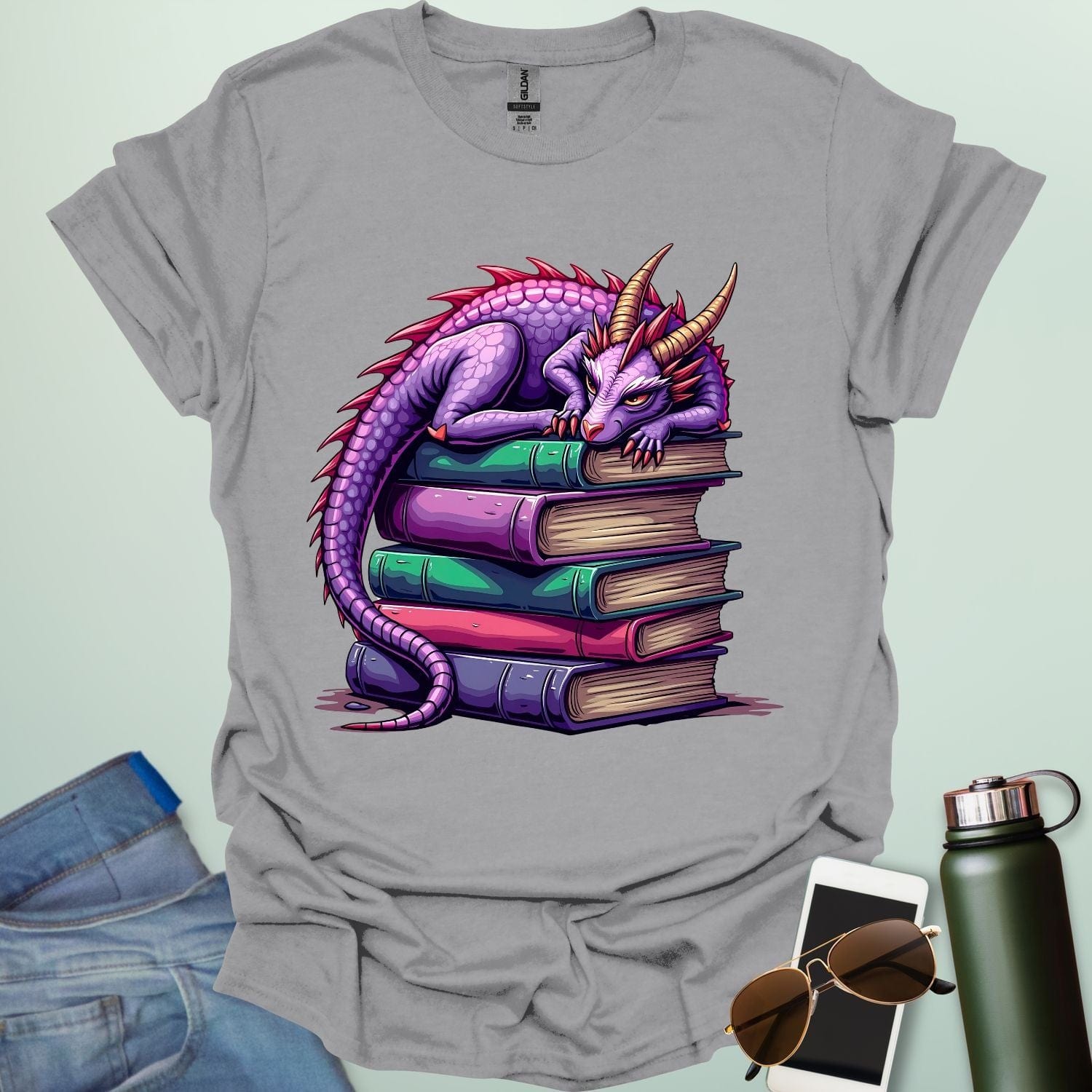 Dragon Fantasy t-shirt featuring whimsical purple dragon curled on a stack of books — perfect for fantasy fans, book lovers, and story geeks.