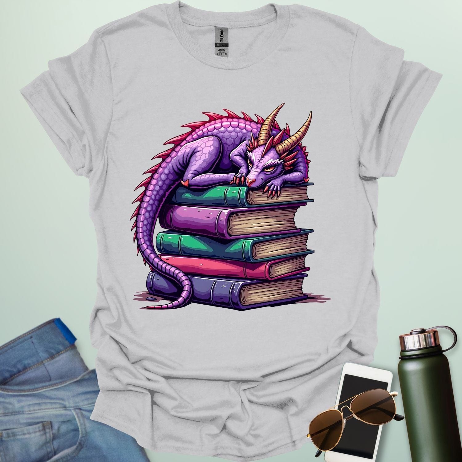 Dragon Fantasy t-shirt featuring whimsical purple dragon curled on a stack of books — perfect for fantasy fans, book lovers, and story geeks.