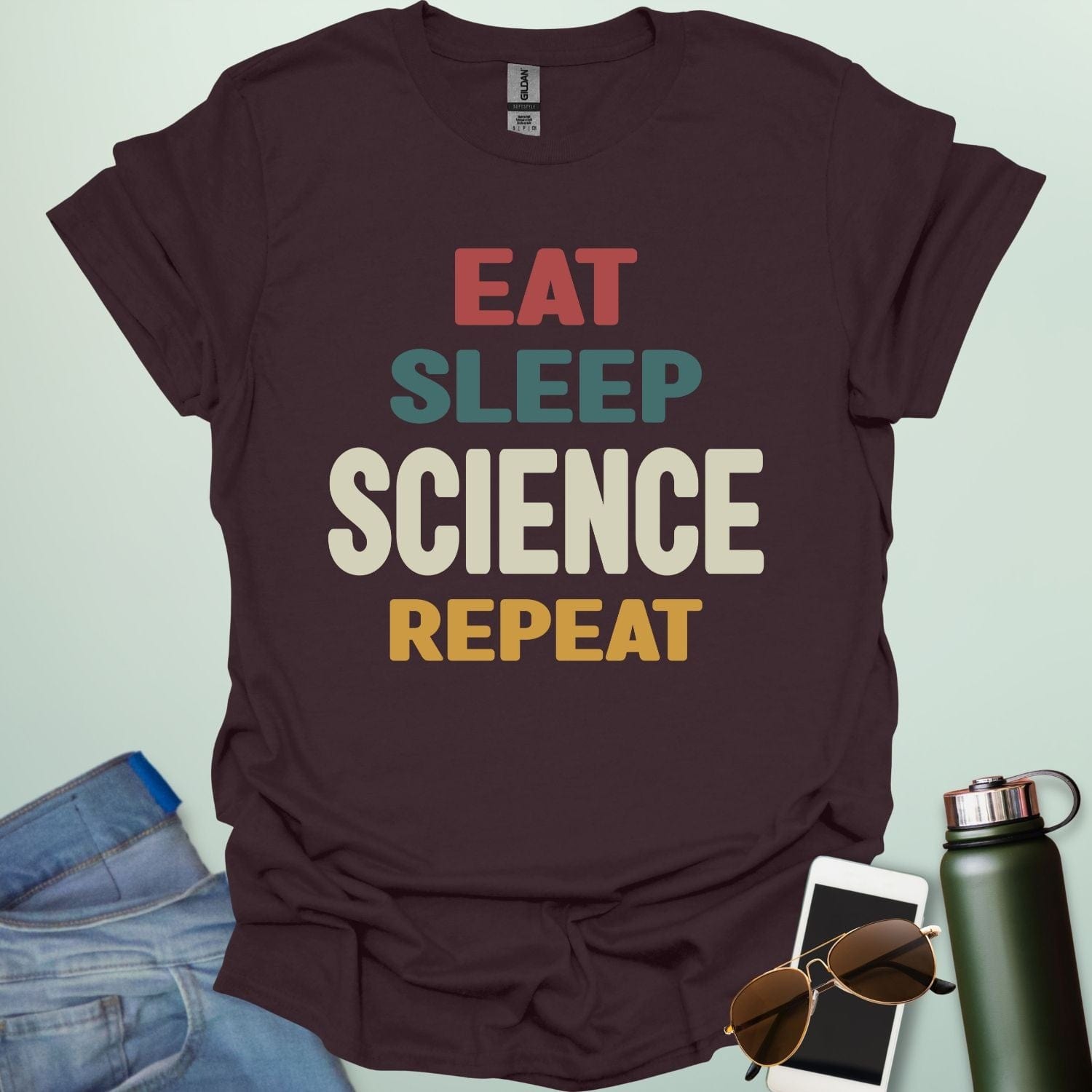 Eat Sleep Science Repeat t-shirt with bold text design — funny science lifestyle shirt for STEM students, teachers, and proud geeks.