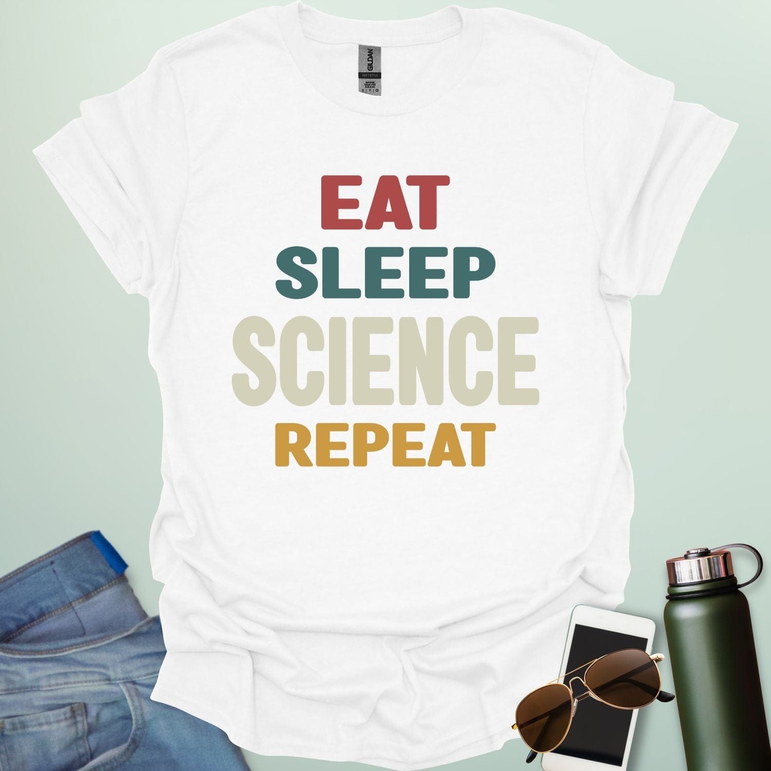 Eat Sleep Science Repeat t-shirt with bold text design — funny science lifestyle shirt for STEM students, teachers, and proud geeks.