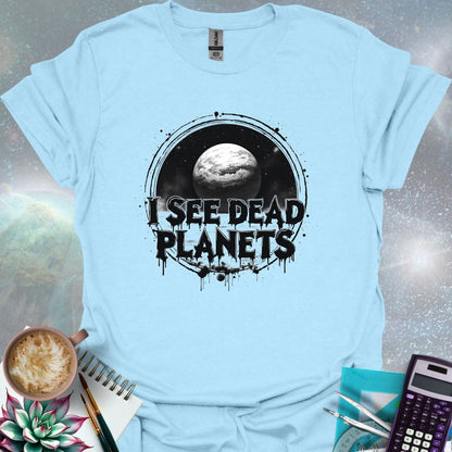 T-shirt design featuring a planet with the text 'I See Dead Planets' in a distressed, gothic font, with splatters and a dark, space-themed background.