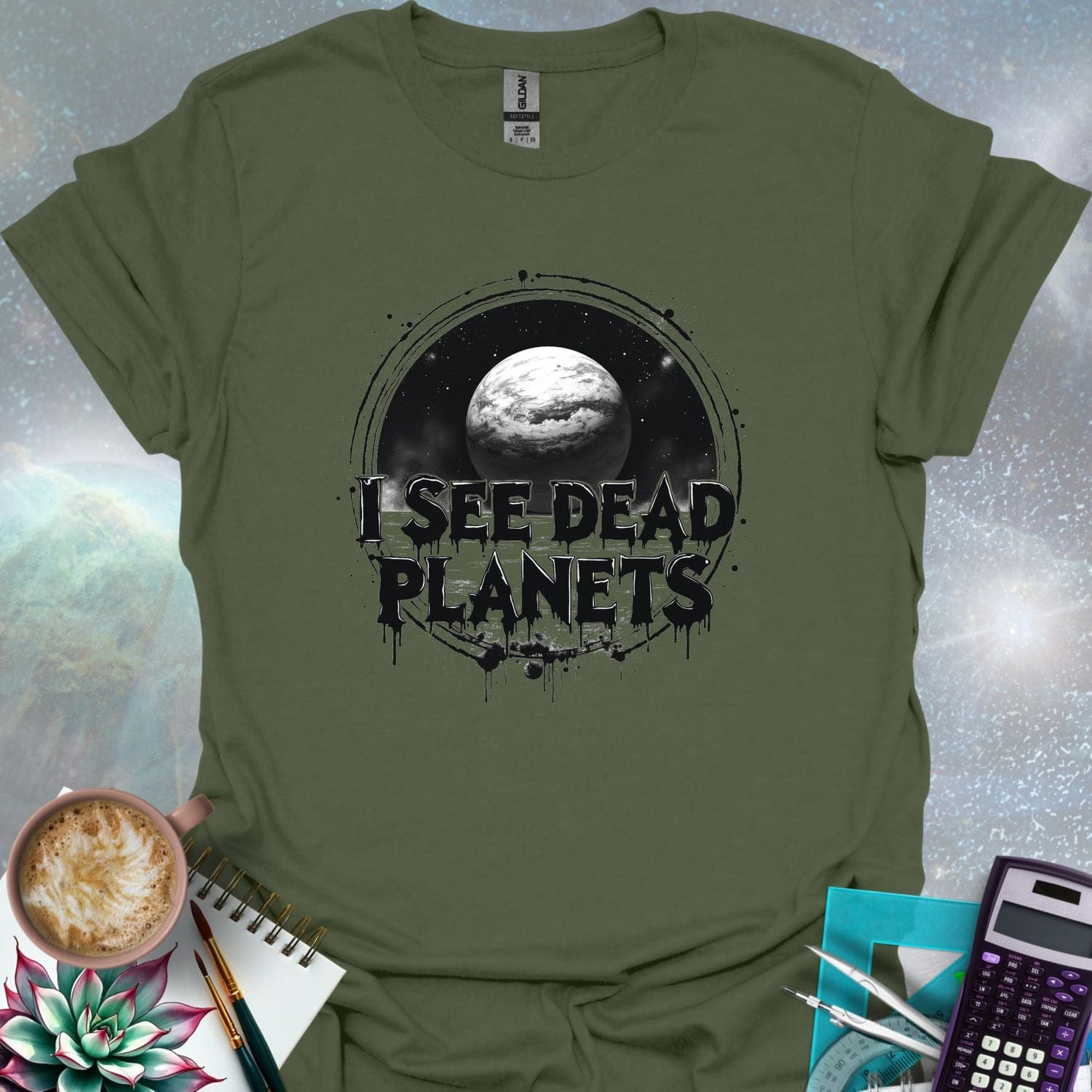 T-shirt design featuring a planet with the text 'I See Dead Planets' in a distressed, gothic font, with splatters and a dark, space-themed background.