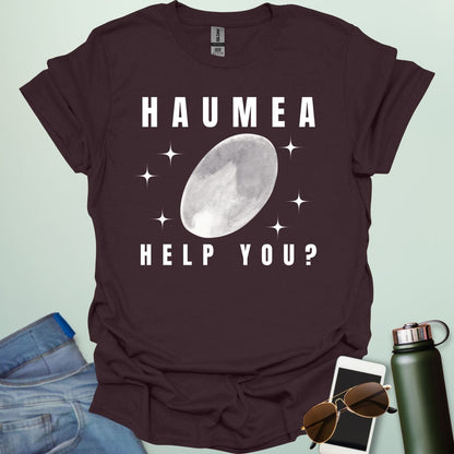 "A dark chocolate t-shirt with a drawing of the dwarf planet Haumea and the text 'HAUMEA HELP YOU?'