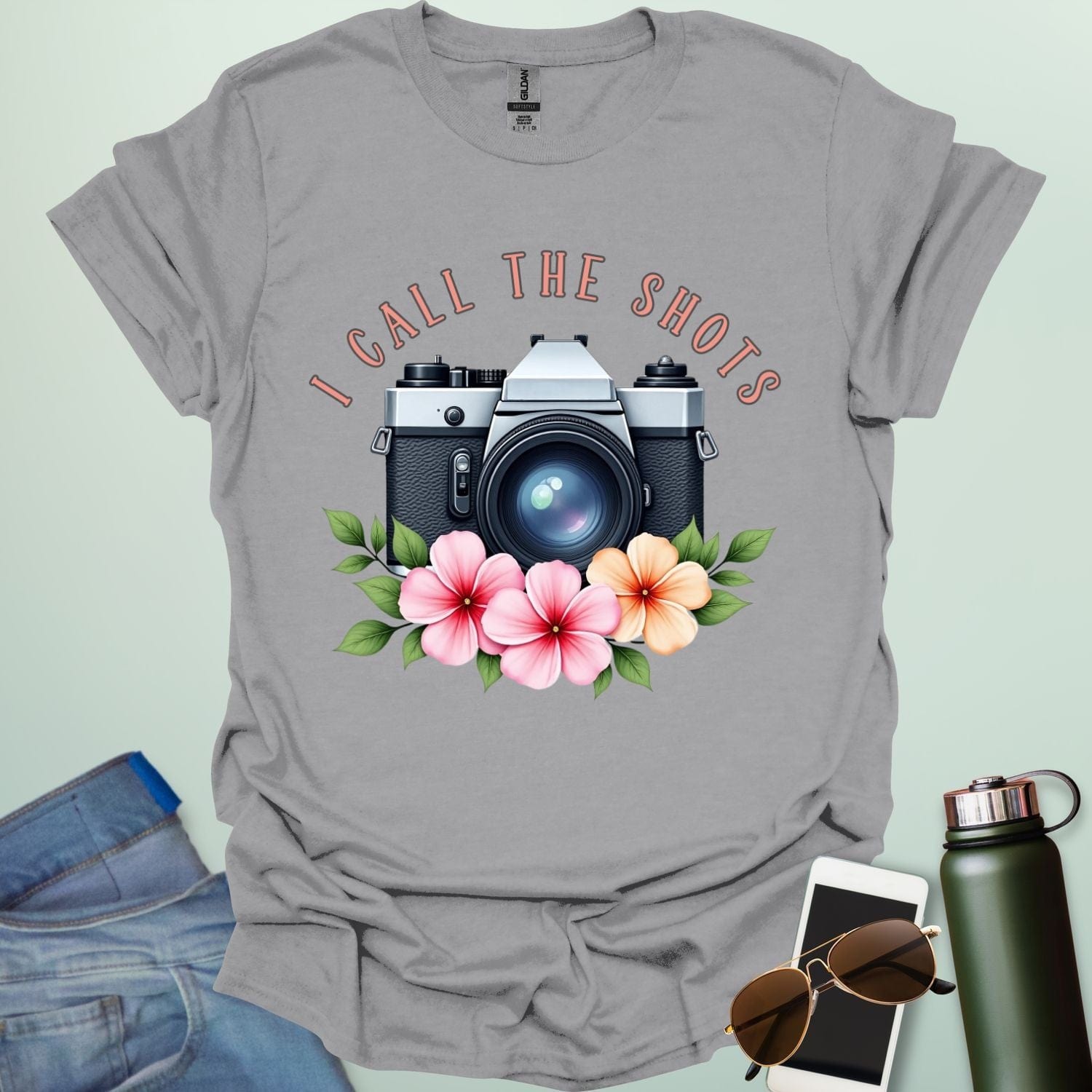 I Call the Shots t-shirt featuring a vintage camera graphic with floral accents — witty photographer humor tee for STEM and art lovers.