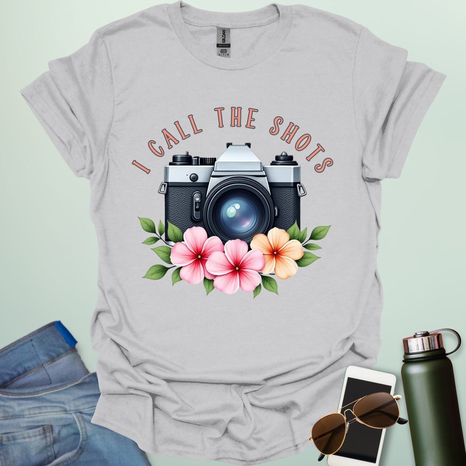I Call the Shots t-shirt featuring a vintage camera graphic with floral accents — witty photographer humor tee for STEM and art lovers.