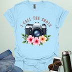 I Call the Shots t-shirt featuring a vintage camera graphic with floral accents — witty photographer humor tee for STEM and art lovers.