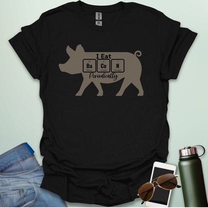 T-shirt design featuring a pig silhouette with the text 'I Eat Bacon Periodically,' where 'Bacon' is spelled using periodic table element symbols.