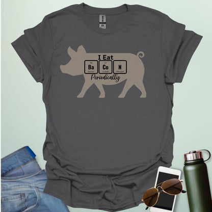 T-shirt design featuring a pig silhouette with the text 'I Eat Bacon Periodically,' where 'Bacon' is spelled using periodic table element symbols.