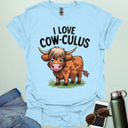 A cute and funny t-shirt featuring a highland cow in a field of flowers and the text 'I Love Cow-culus,' a perfect gift for math teachers and students.