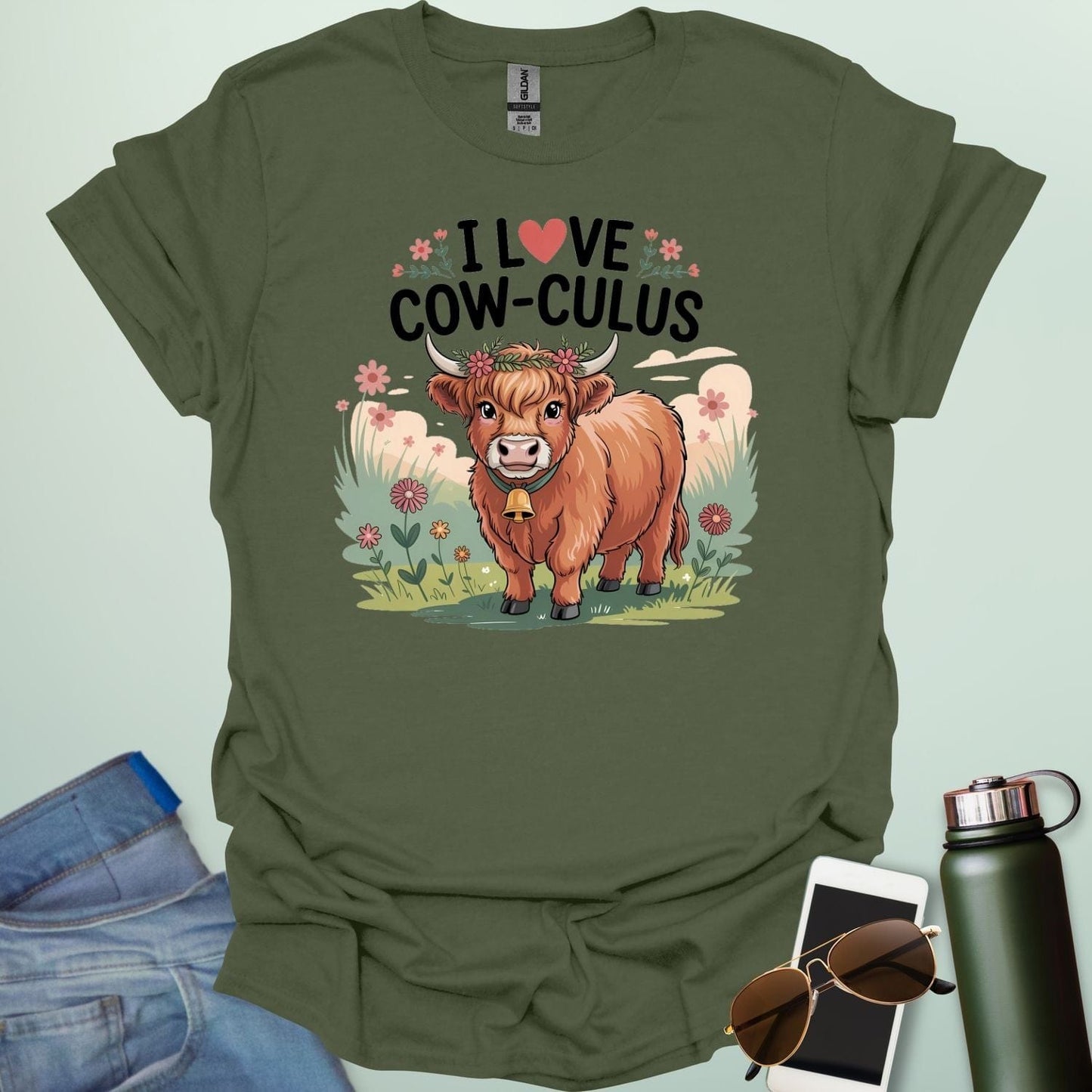 A military green t-shirt with a cute illustration of a cow in a field and the text 'I love Cow-culus' with a heart symbol.