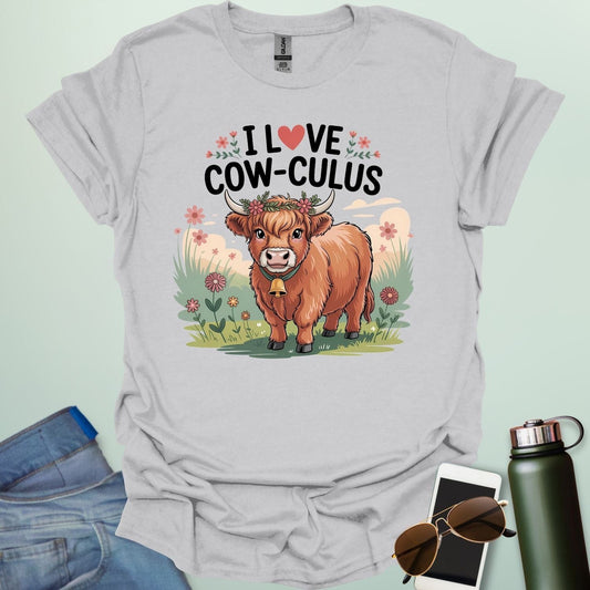 An ice grey t-shirt with a cute illustration of a cow in a field and the text 'I love Cow-culus' with a heart symbol.