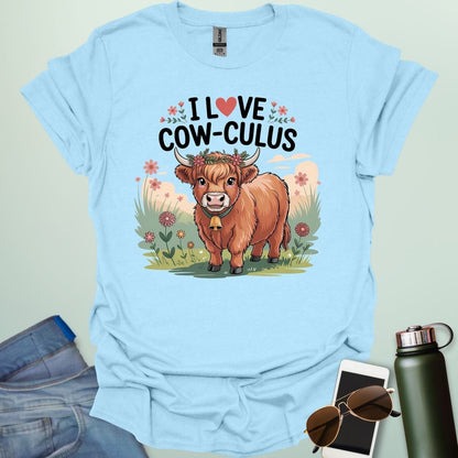 A light blue t-shirt with a cute illustration of a cow in a field and the text 'I love Cow-culus' with a heart symbol.