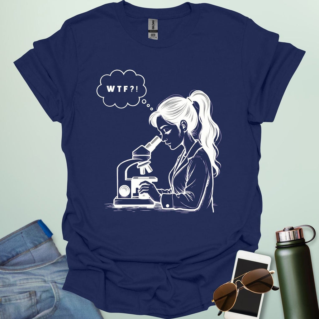 A funny t-shirt for scientists with a line drawing of a woman looking through a microscope and a thought bubble with the text 'WTF?!'