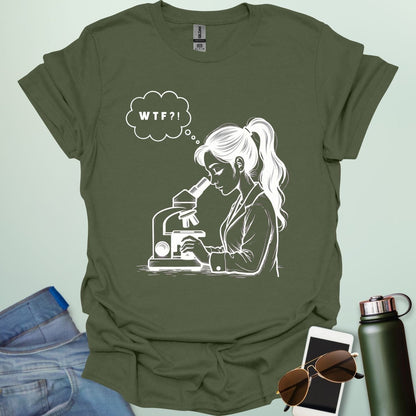 A funny t-shirt for scientists with a line drawing of a woman looking through a microscope and a thought bubble with the text 'WTF?!'