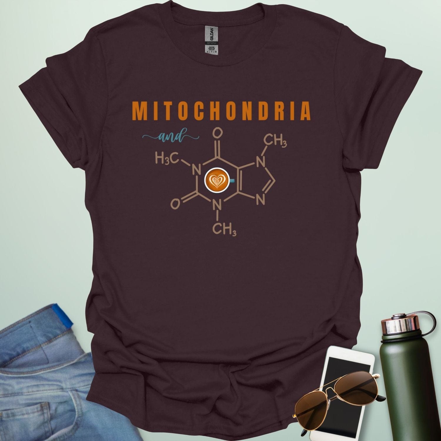A dark chocolate t-shirt with the text 'MITOCHONDRIA and' above a graphic of the caffeine chemical structure with a coffee cup icon.