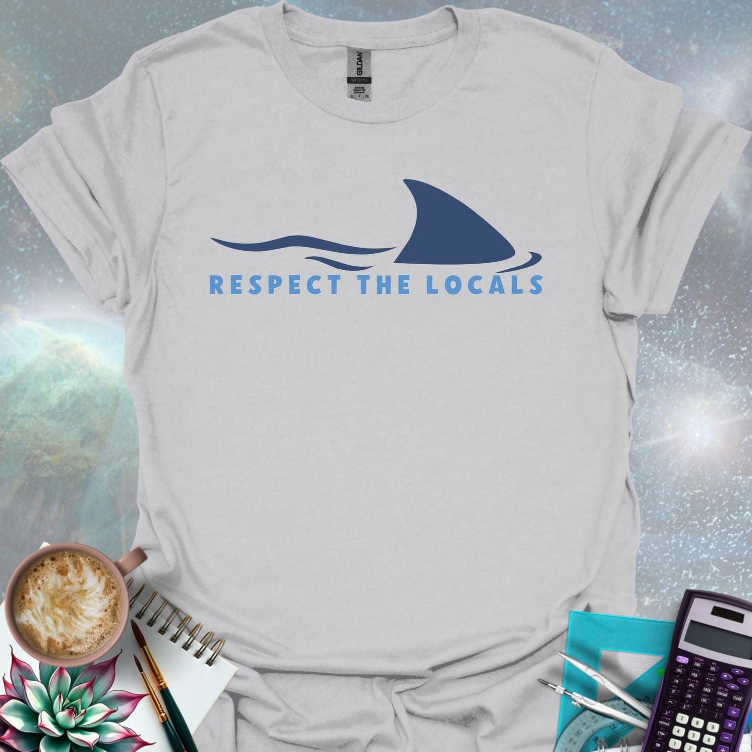 A blue shark fin rising above blue ocean waves, with the text 'RESPECT THE LOCALS' below.